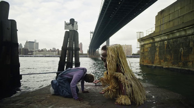 a man and a woman dressed in costume on a dock