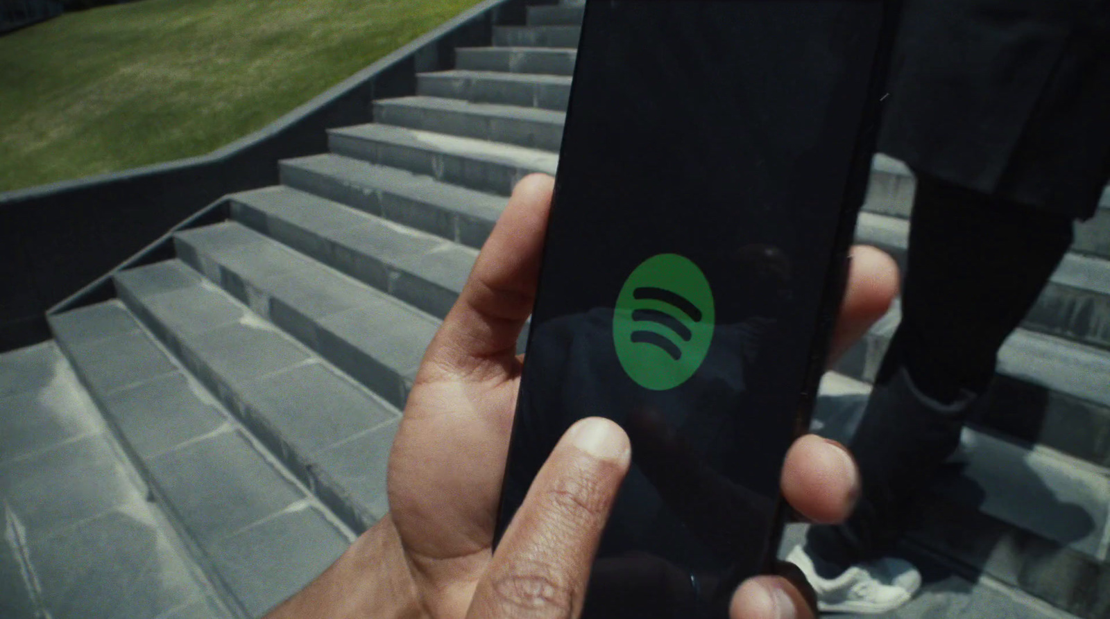 a person holding a cell phone with a green spot on it