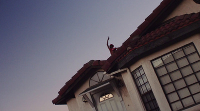 a person standing on the roof of a house