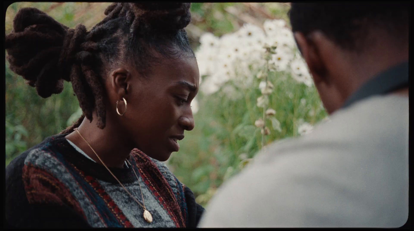 a woman with dreadlocks standing next to a man