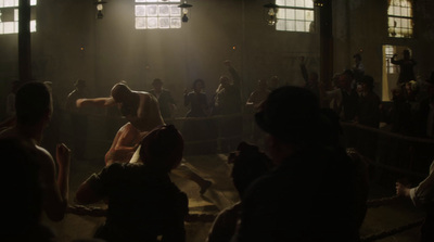 a group of people standing around a boxing ring