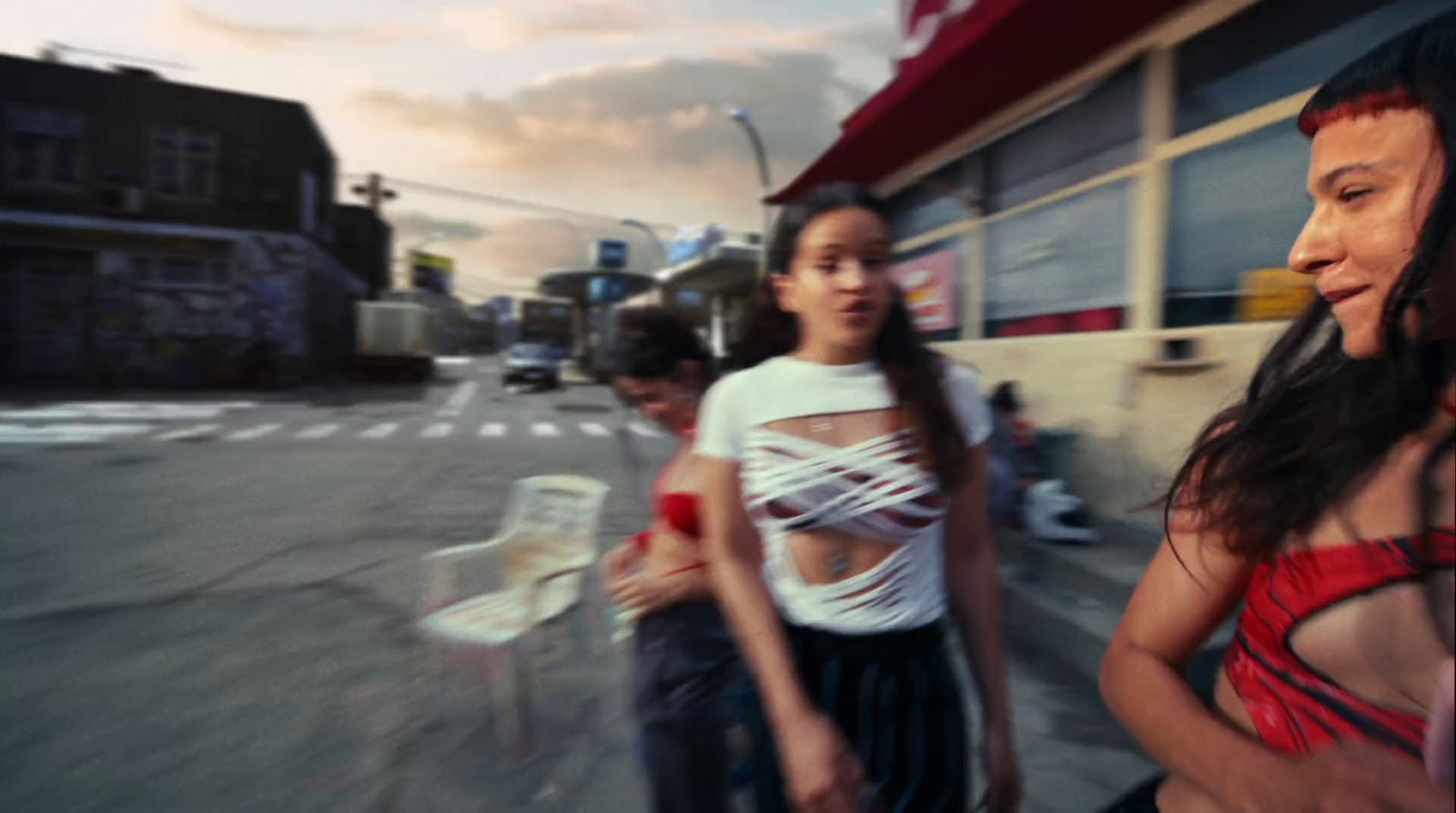 a couple of women standing next to each other on a street