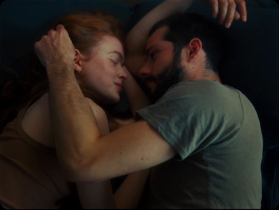 a man and a woman laying in bed together