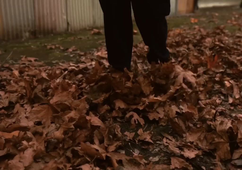 a person standing in a pile of leaves