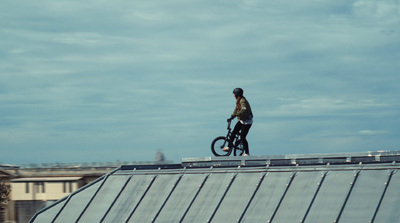 a man riding a bike on top of a roof