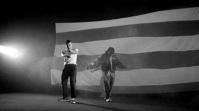 a couple of men standing on top of a stage