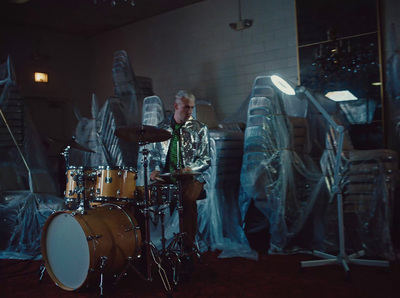 a man is playing drums in a room