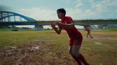 a man in a red shirt is playing baseball