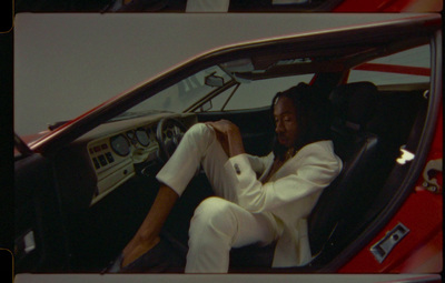 a man sitting in a car with his feet up