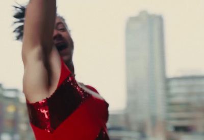 a woman in a red dress holding a cell phone