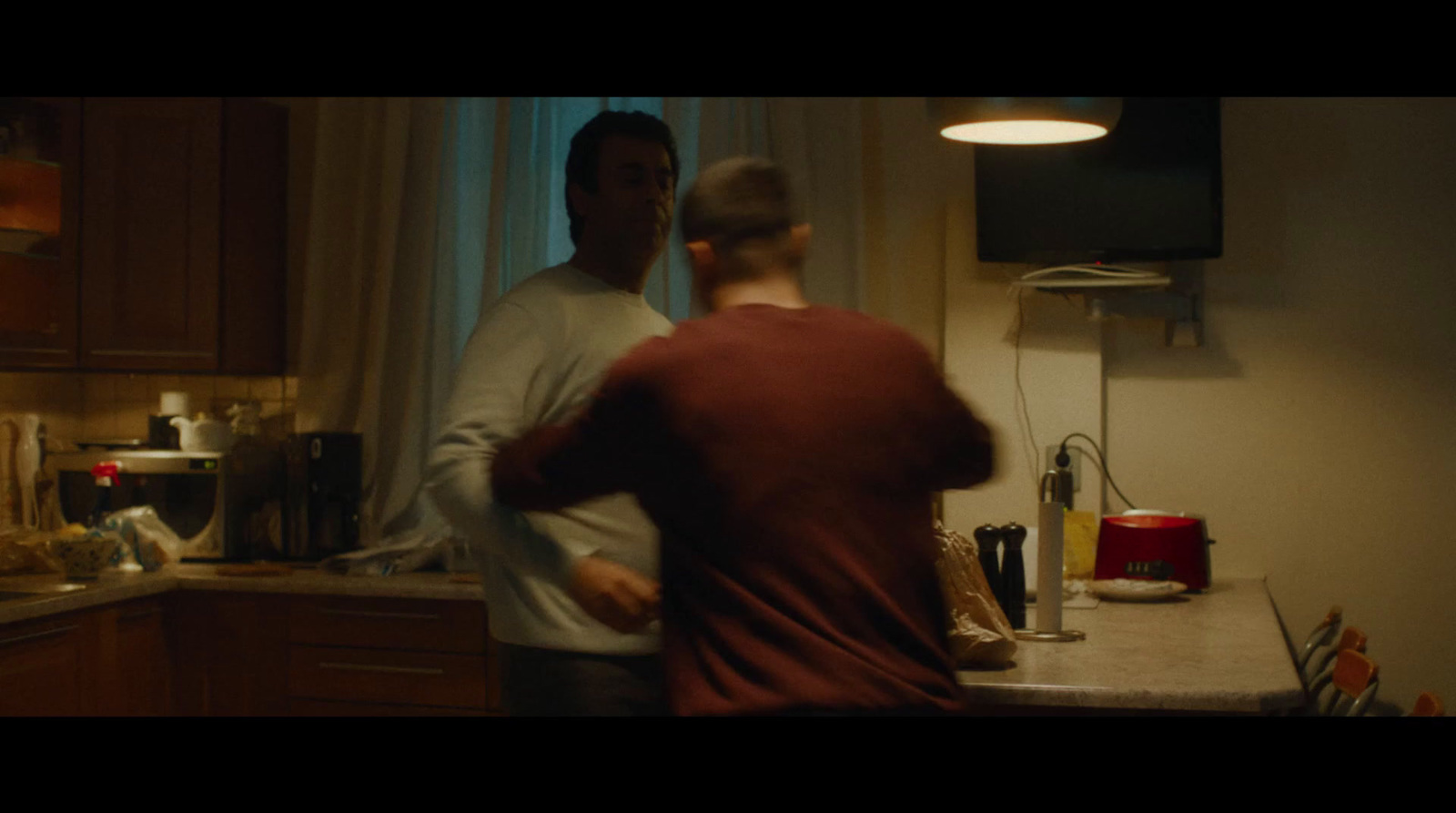 a man and a woman standing in a kitchen