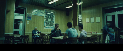 a group of people sitting at a table in a restaurant