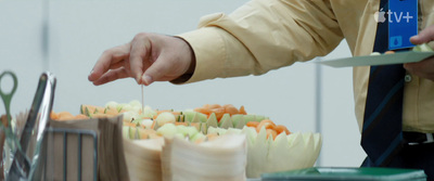 a person cutting food with a knife on a table