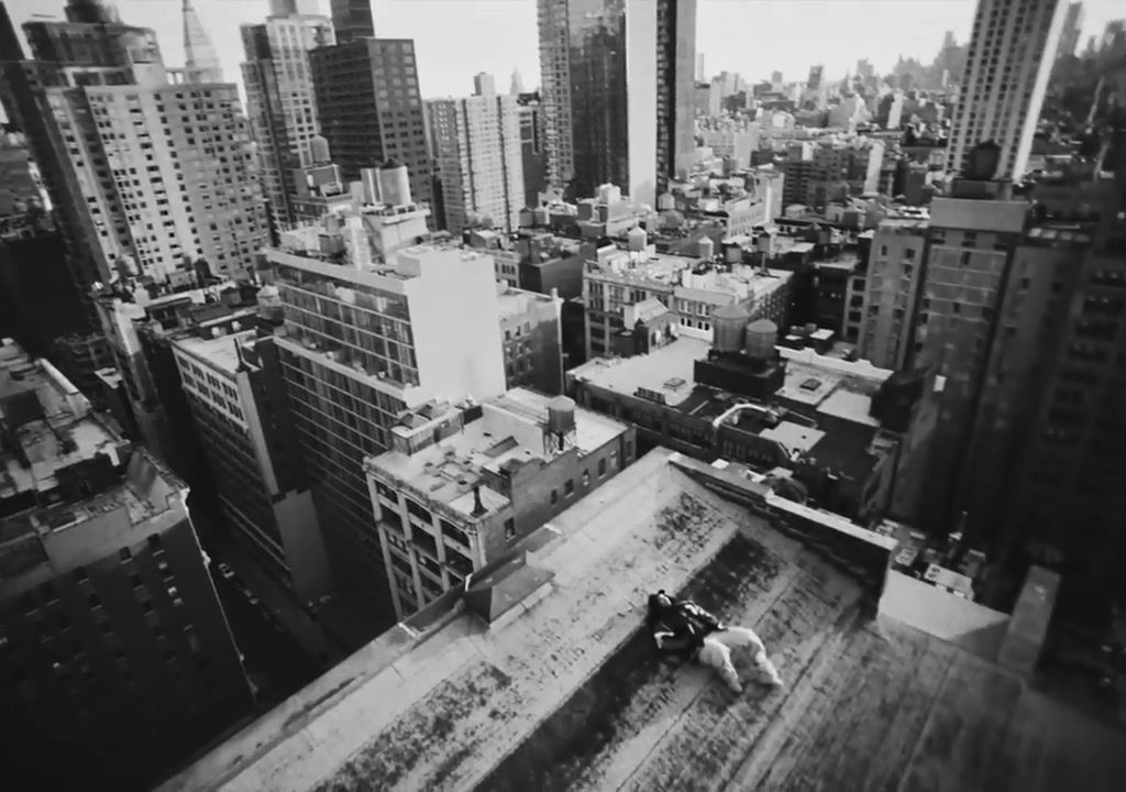 a black and white photo of a city with tall buildings