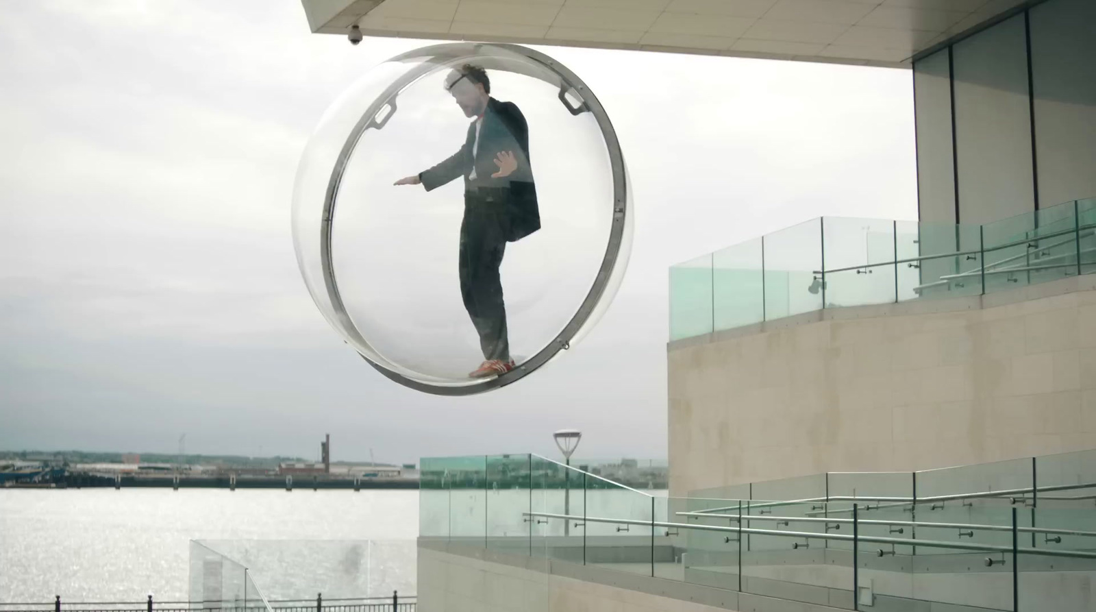 a man in a suit is suspended from a circular object