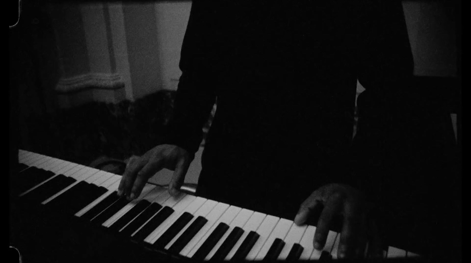 a person playing a piano in a dark room