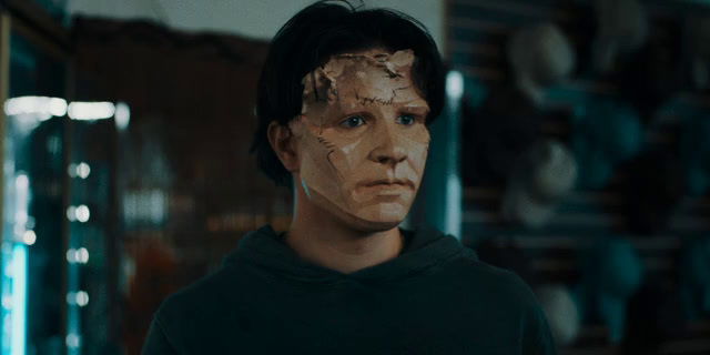 a man with a face mask on in a room