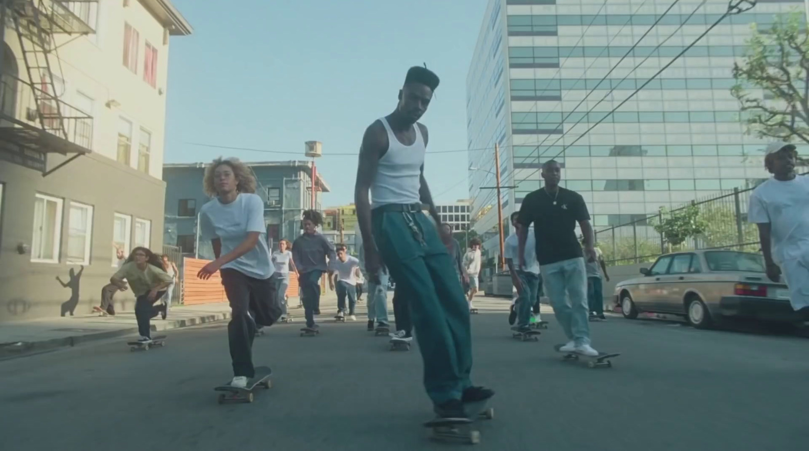 a group of young men riding skateboards down a street