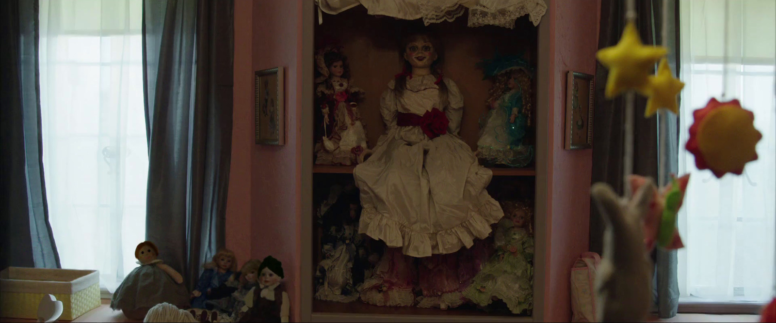 a doll in a cabinet with other dolls in the background