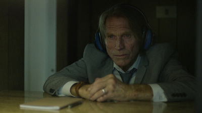 a man wearing headphones sitting at a table