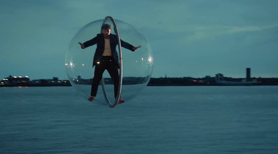 a man in a suit is floating in a bubble