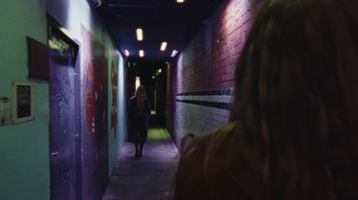 a person walking down a long narrow hallway