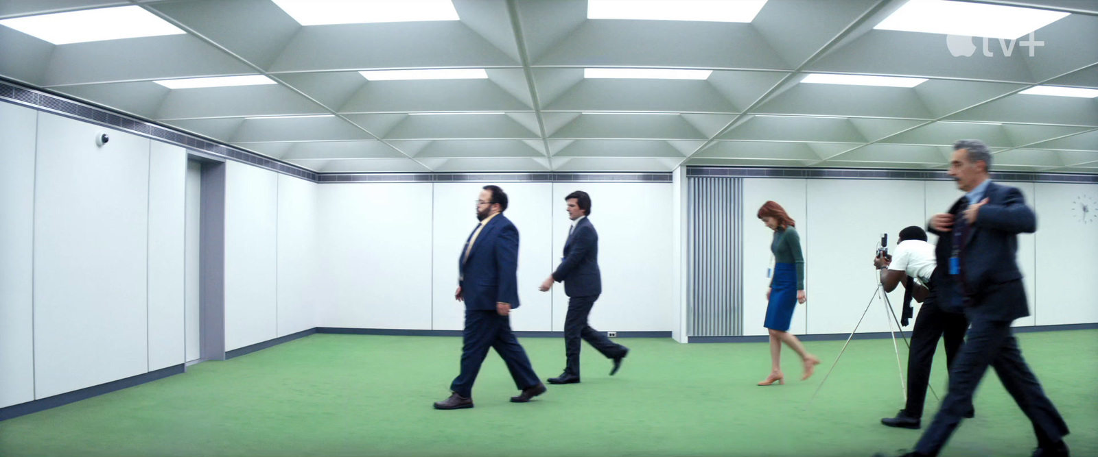 a group of people walking through a hallway