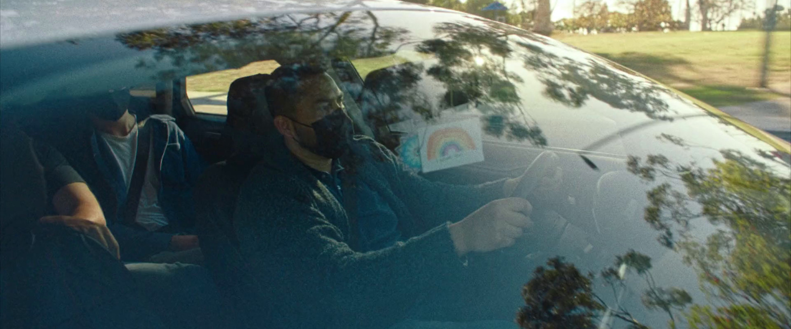 a group of people sitting in the back seat of a car