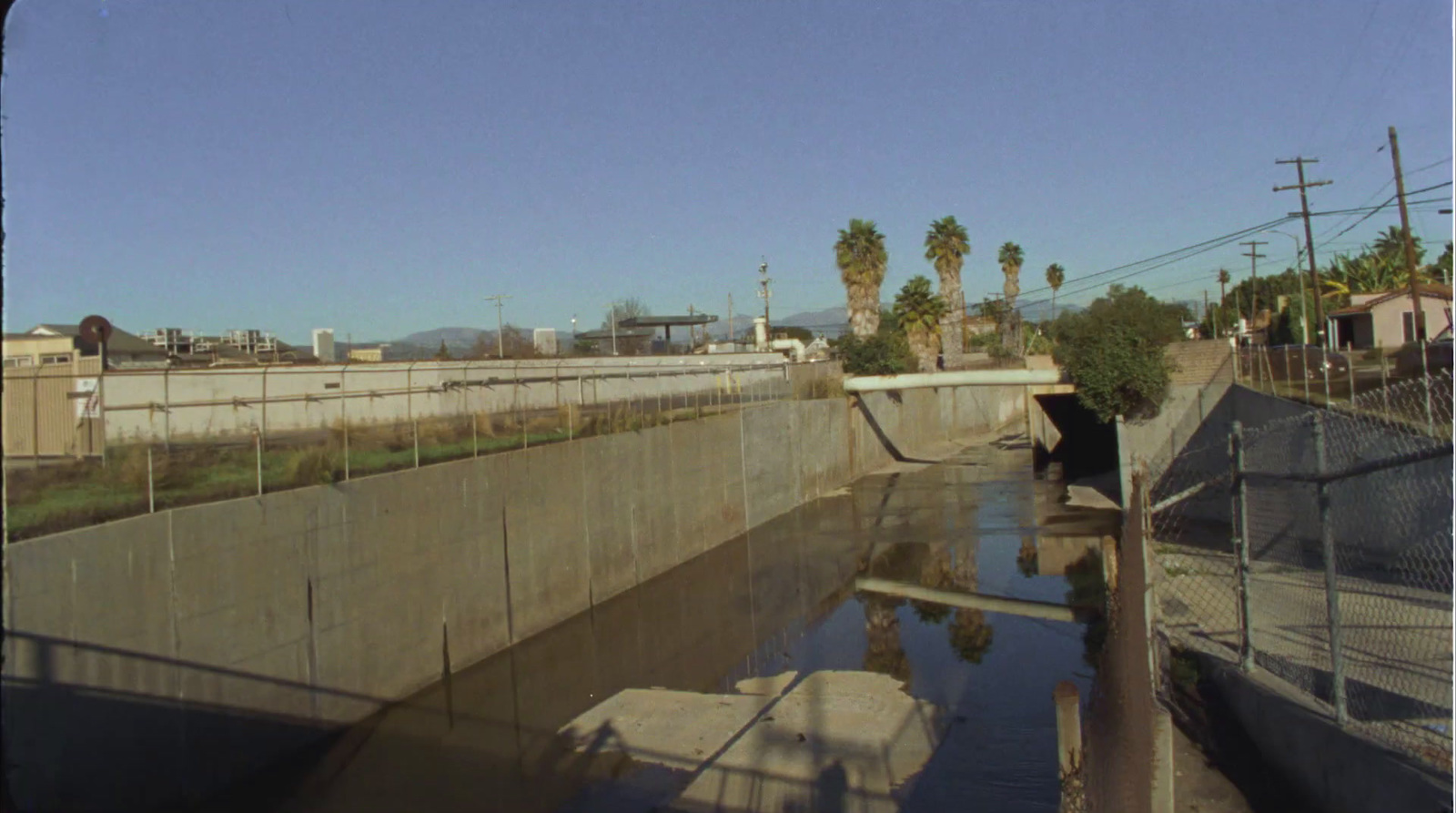 a view of a waterway with palm trees in the background