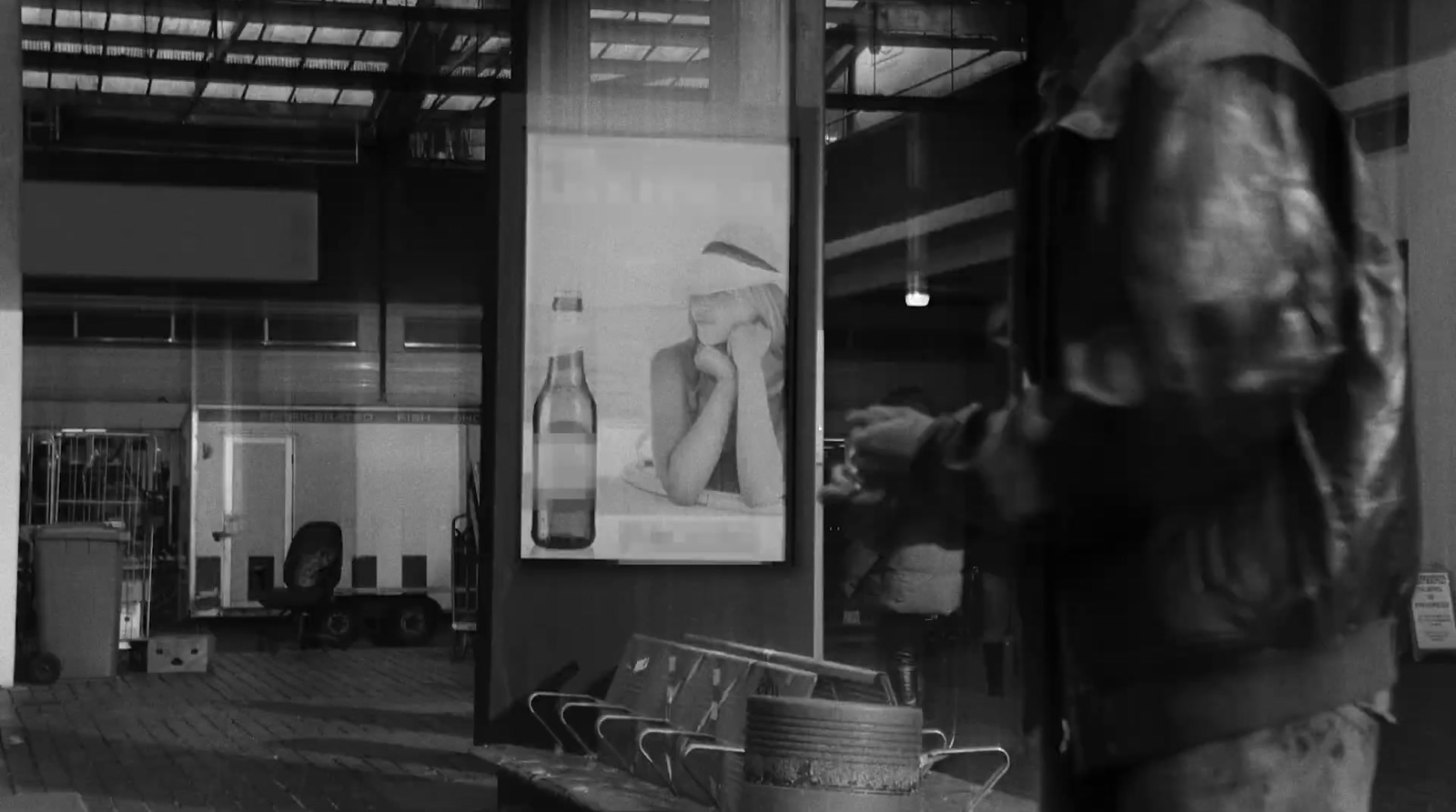 a black and white photo of a man standing in front of a store