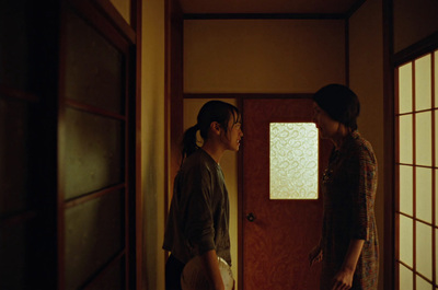 a man and a woman standing in front of a door