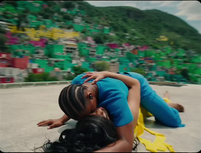 a woman laying on the ground next to another woman