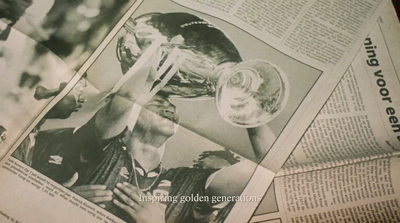 a newspaper with a picture of a man holding a trophy