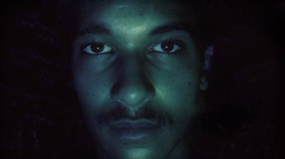 a close up of a person in a dark room