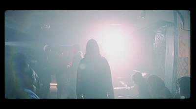 a group of people standing around in a dark room