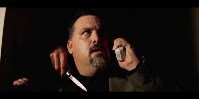 a man holding a cell phone to his ear