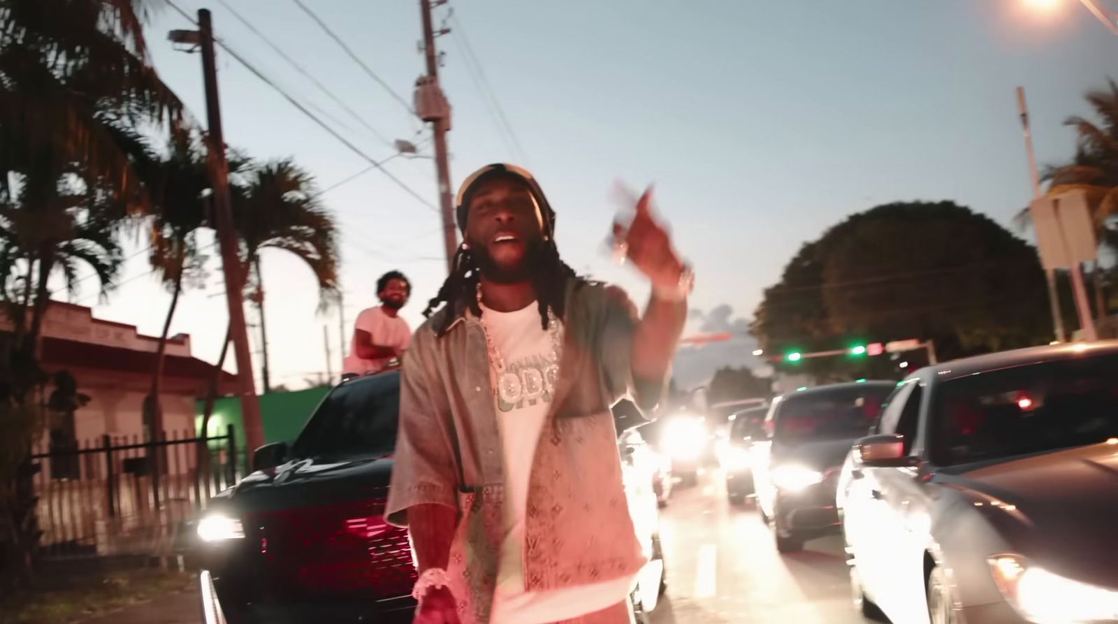 a man standing in the middle of a street surrounded by traffic