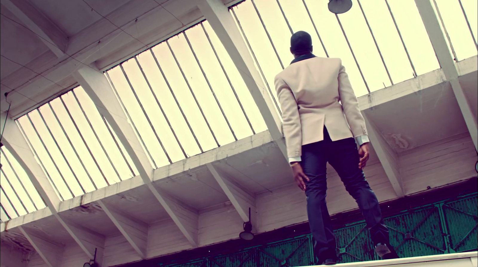 a woman standing on a ledge in a building