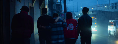 a group of people standing on a street at night