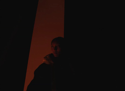 a man standing in the dark with a cell phone in his hand