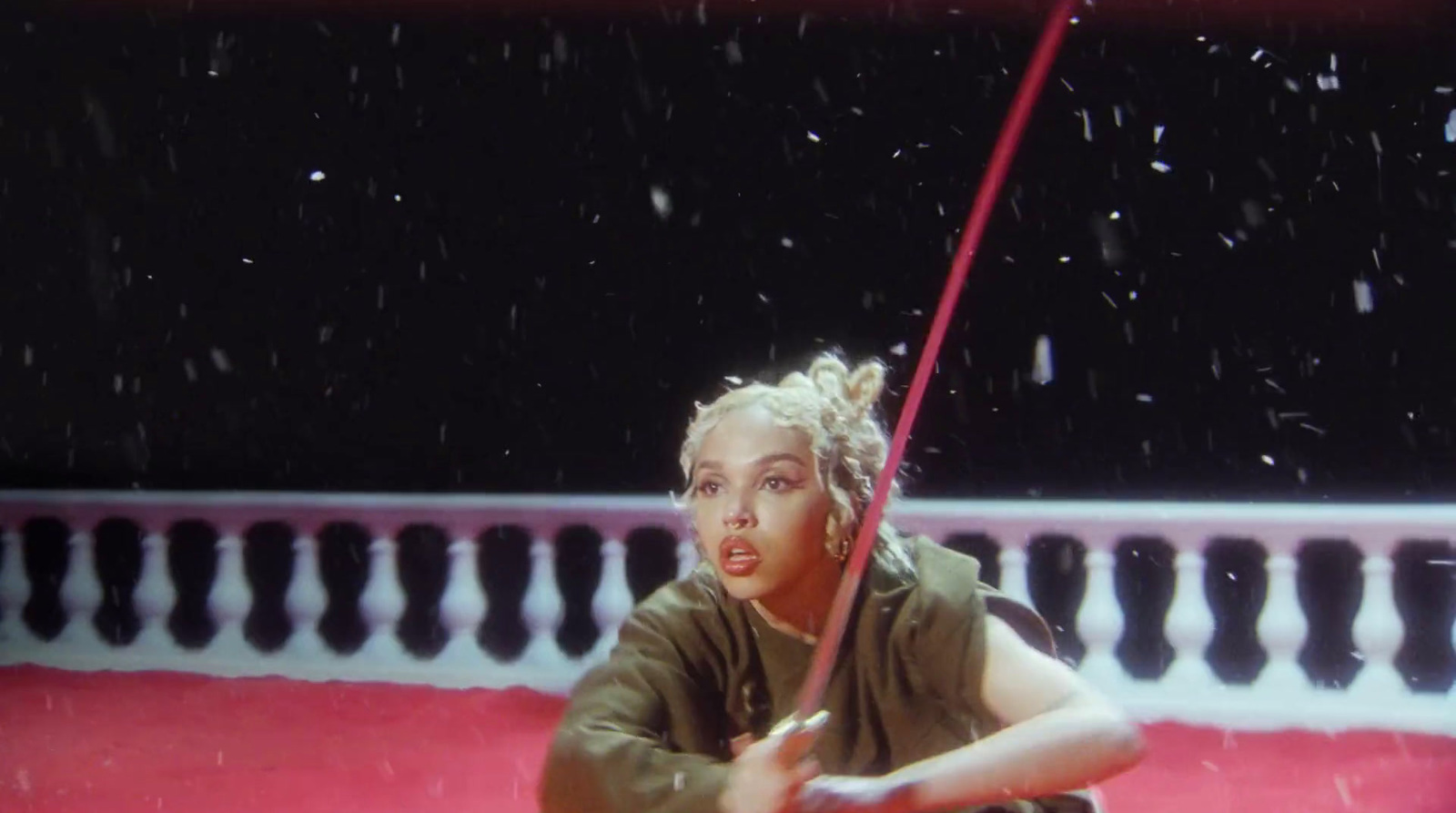 a woman holding a red umbrella in the rain