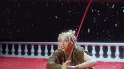 a woman holding a red umbrella in the rain