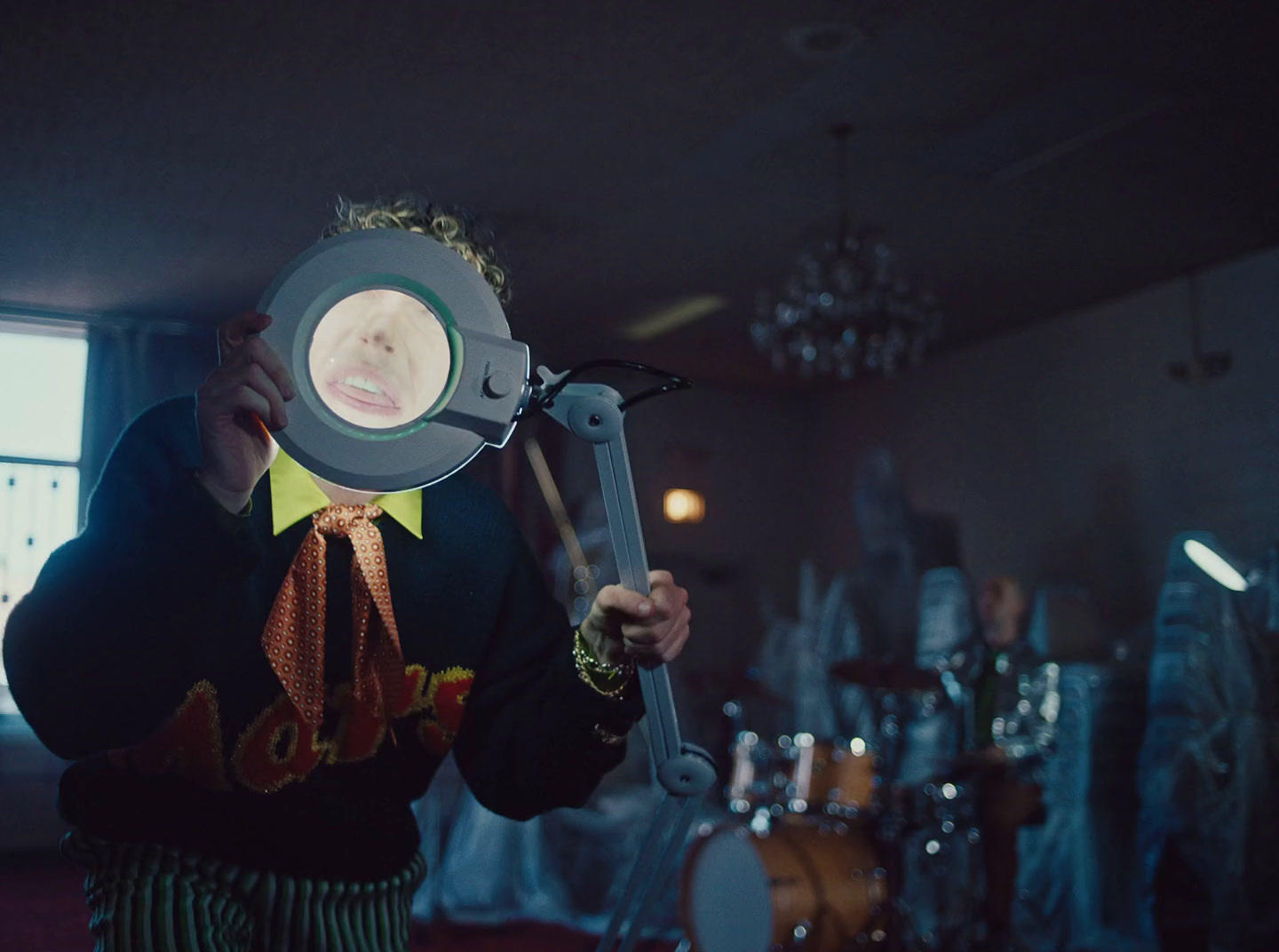 a man holding a magnifying glass over his face