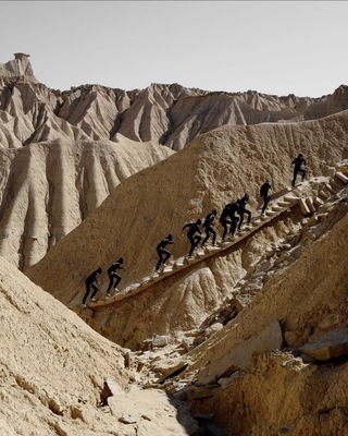 a group of people climbing up a mountain