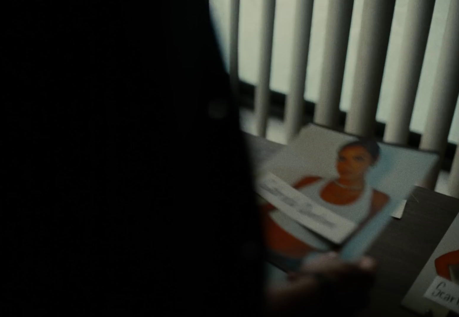 a person holding a book in front of a radiator