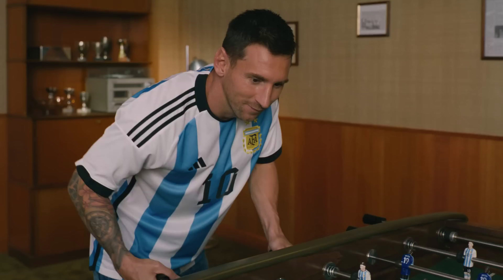 a man playing a game of foosball in a room