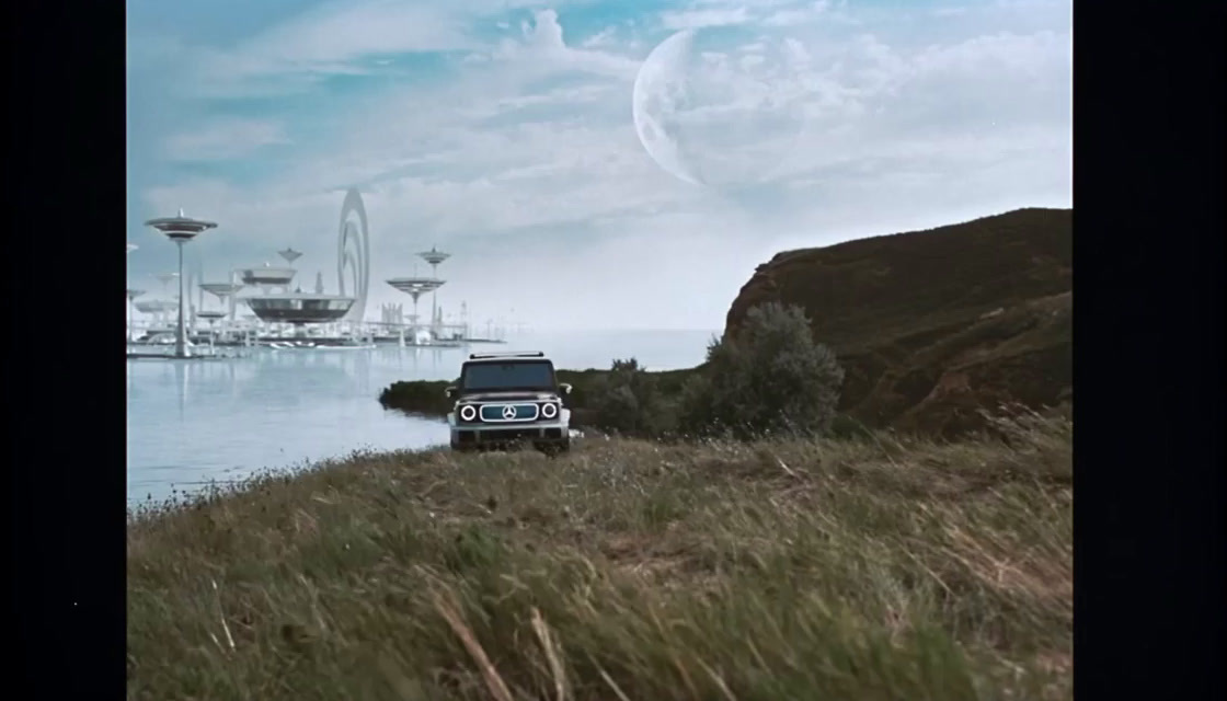 a jeep driving down a hill next to a body of water