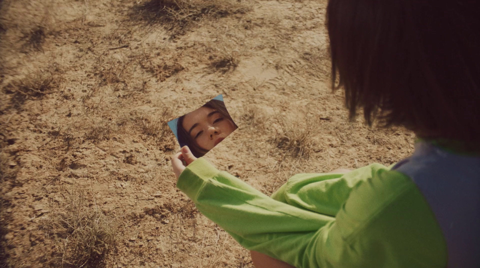 a young child holding a cell phone to take a picture