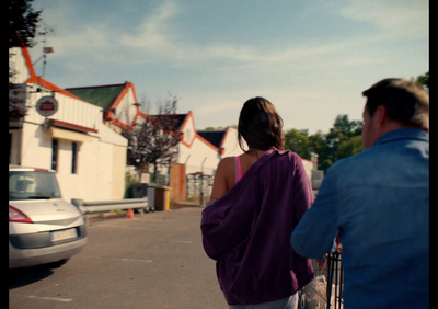 a man and a woman walking down a street