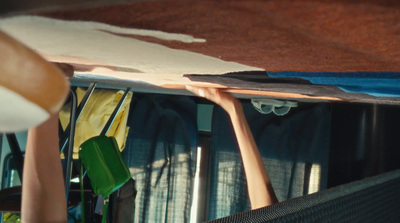 a surfboard sitting on top of a table next to a window